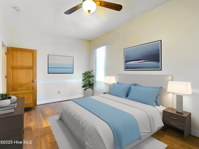 bedroom with ceiling fan and dark hardwood / wood-style floors