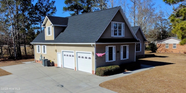 exterior space with cooling unit and a garage