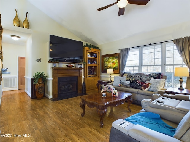 living room with ceiling fan, hardwood / wood-style flooring, and high vaulted ceiling