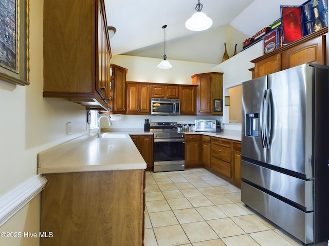 kitchen featuring appliances with stainless steel finishes, sink, hanging light fixtures, vaulted ceiling, and light tile patterned floors