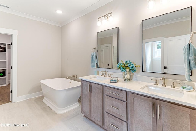 bathroom featuring crown molding, vanity, tile patterned flooring, and a bathtub