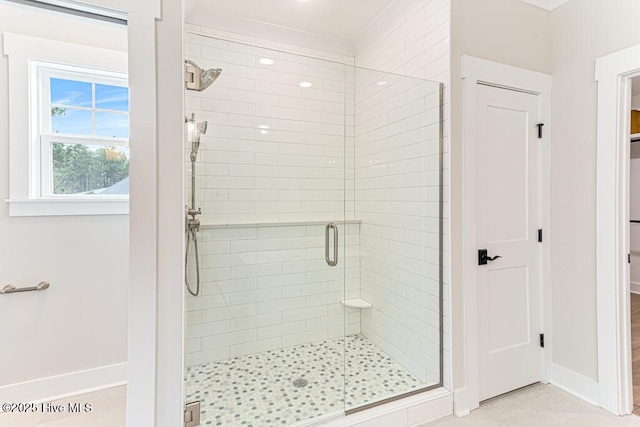 bathroom featuring a shower with door