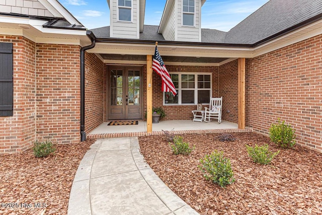 view of exterior entry with covered porch