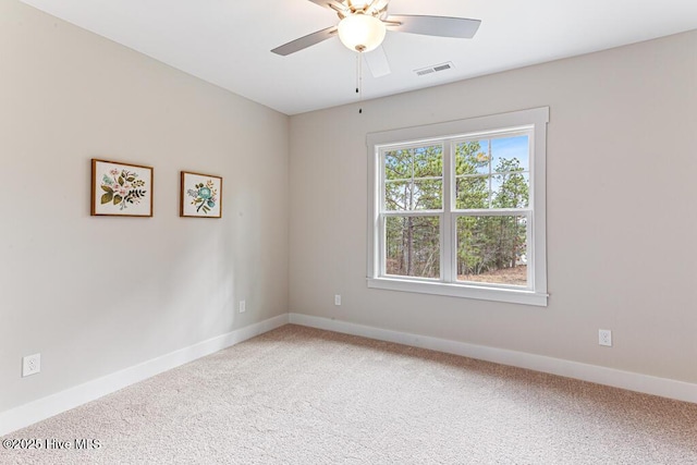 empty room featuring carpet flooring and ceiling fan