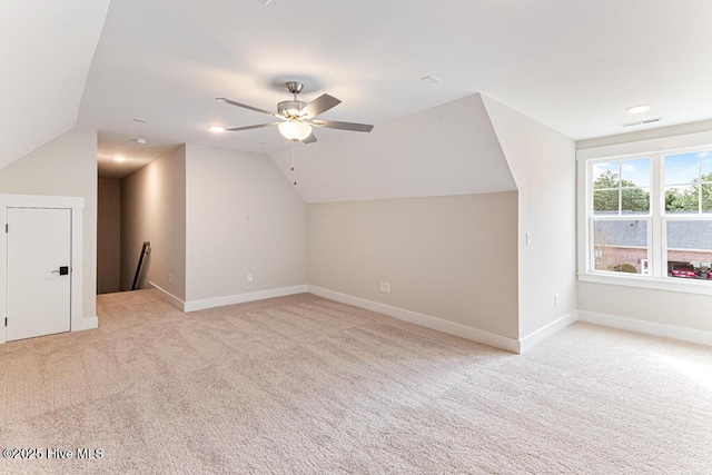 bonus room featuring lofted ceiling, light colored carpet, and ceiling fan