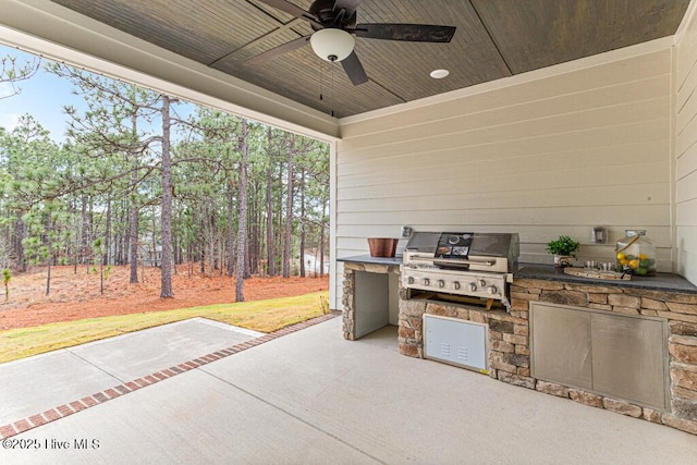 view of patio featuring ceiling fan, area for grilling, and grilling area