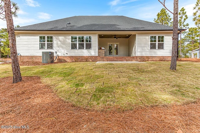 rear view of house featuring central AC, ceiling fan, and a yard