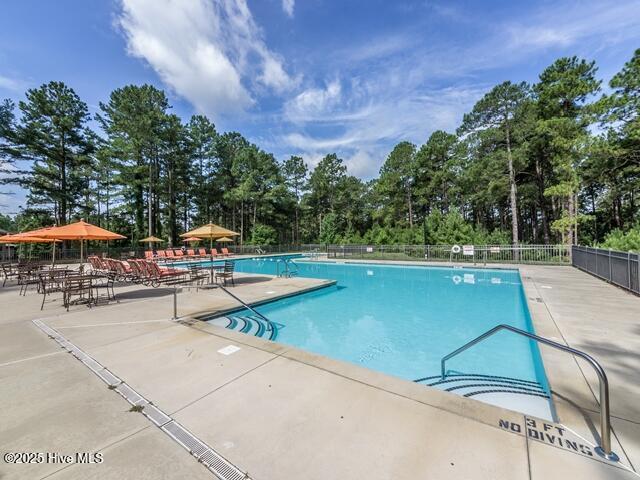 view of swimming pool featuring a patio area