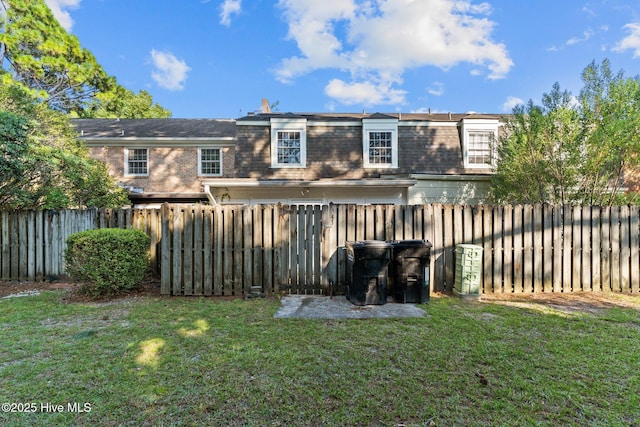 rear view of property featuring a yard