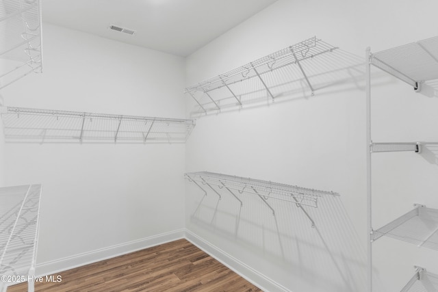 spacious closet featuring hardwood / wood-style flooring