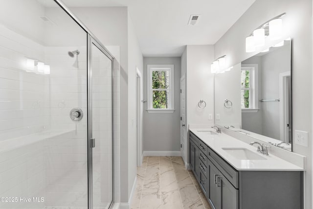 bathroom with vanity and a shower with shower door