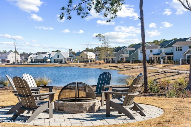 view of patio with a water view and an outdoor fire pit