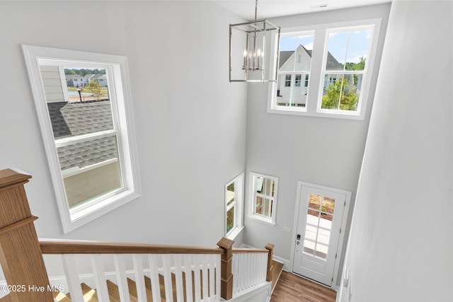 staircase featuring a notable chandelier and hardwood / wood-style flooring