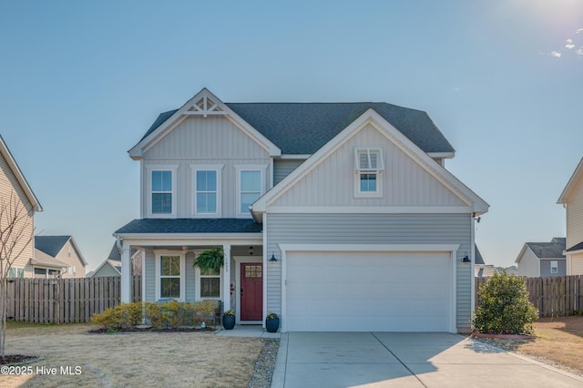 view of front facade with concrete driveway, a shingled roof, board and batten siding, and fence