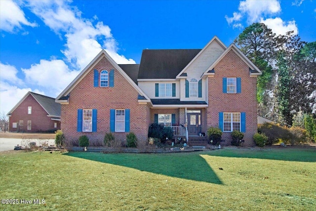 view of front of home with a front yard and covered porch