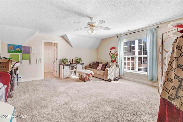 living area with a textured ceiling, ceiling fan, lofted ceiling, and light carpet