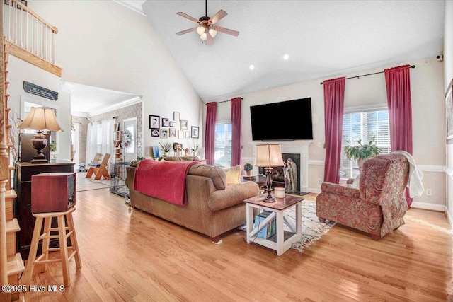 living room featuring high vaulted ceiling, ceiling fan, and light hardwood / wood-style floors