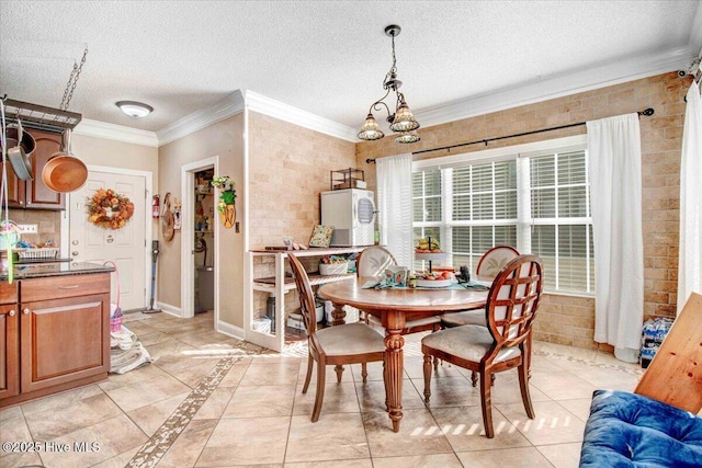 tiled dining space featuring a chandelier, crown molding, and a textured ceiling