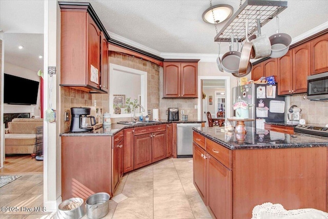 kitchen with decorative backsplash, a textured ceiling, stainless steel appliances, and dark stone counters