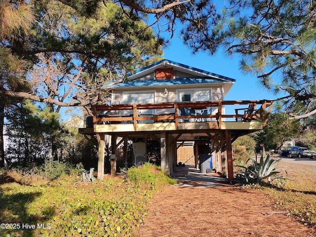 back of property featuring a deck and a carport