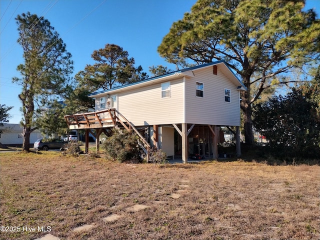 back of property with a wooden deck