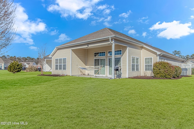 rear view of property featuring a yard