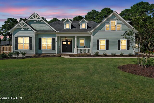 view of front of home featuring a front yard, a garage, and an outdoor structure