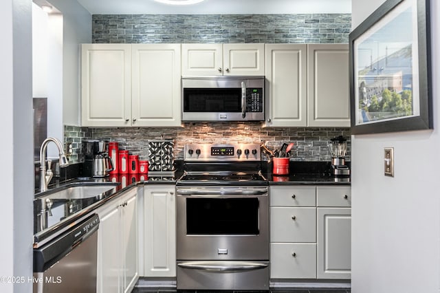 kitchen featuring sink, stainless steel appliances, and white cabinetry