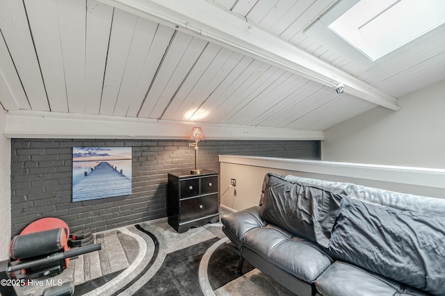 carpeted cinema with wooden ceiling, brick wall, and beamed ceiling