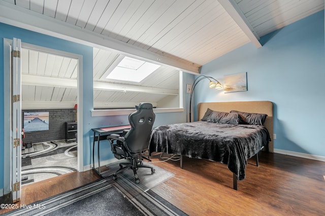 bedroom with vaulted ceiling with skylight and wood-type flooring