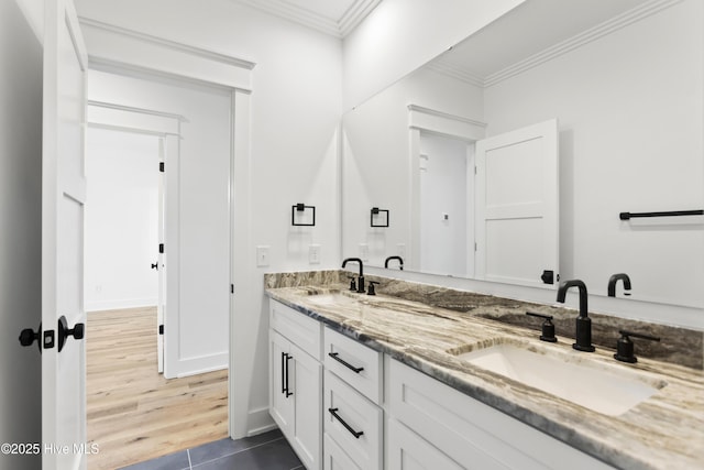 bathroom featuring vanity, tile patterned flooring, and crown molding