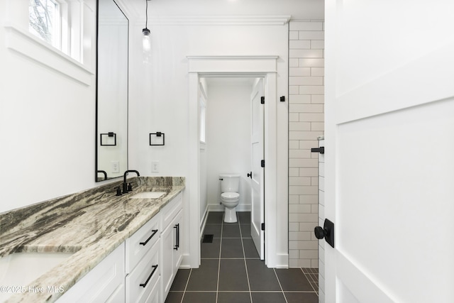 bathroom featuring toilet, vanity, and tile patterned flooring