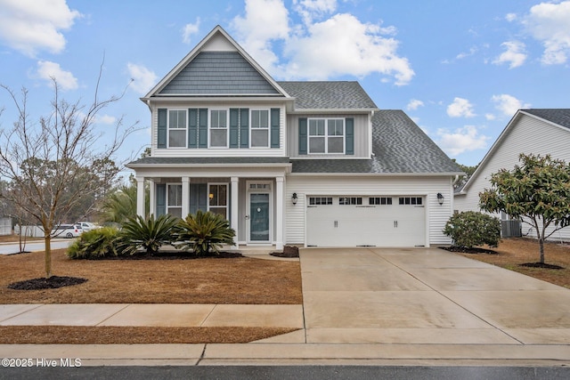 view of front of property with a garage and central AC