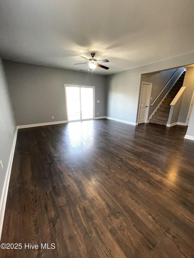 living room featuring ceiling fan and dark hardwood / wood-style flooring