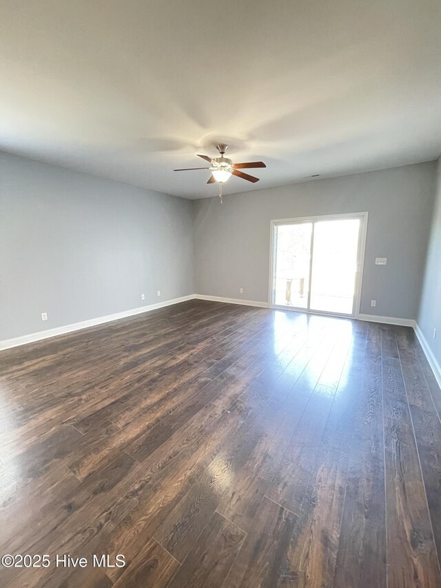 living room with ceiling fan and dark hardwood / wood-style floors