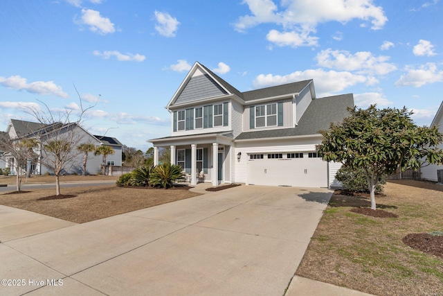 view of front of house featuring a porch, a garage, and a front yard