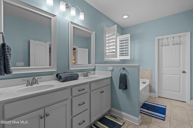 bathroom with tile patterned floors, a bath, and vanity