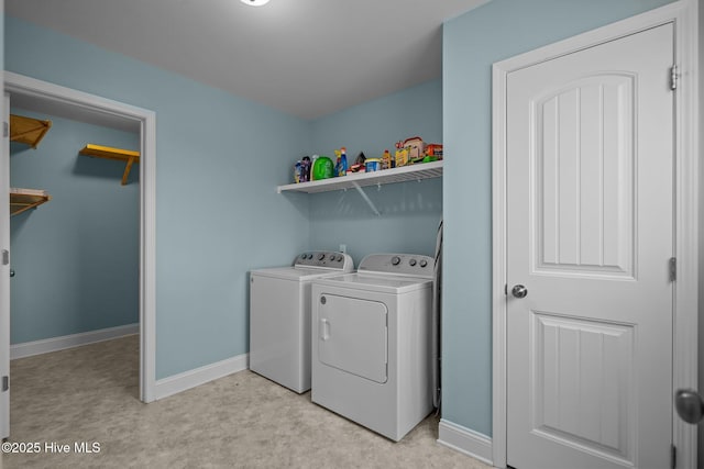 clothes washing area with washing machine and dryer