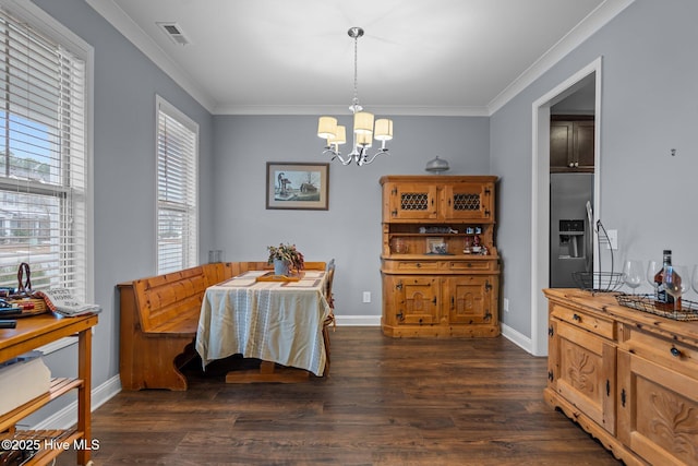 dining space featuring a notable chandelier, dark wood-type flooring, and ornamental molding