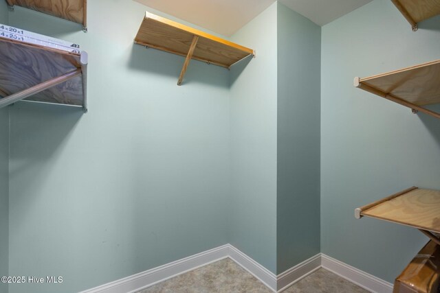 bedroom featuring light colored carpet and ceiling fan