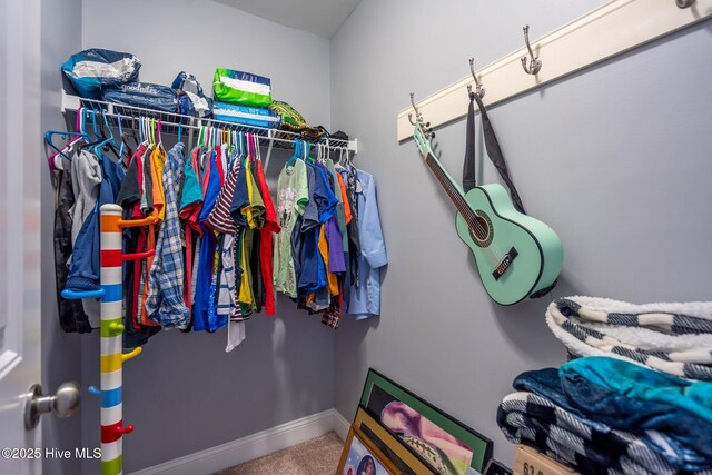 walk in closet featuring carpet floors