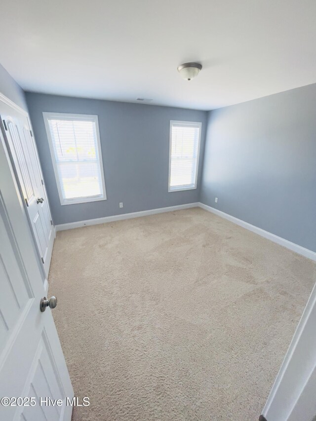 bedroom with light carpet and a closet