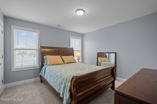 living room featuring plenty of natural light, light colored carpet, and ceiling fan