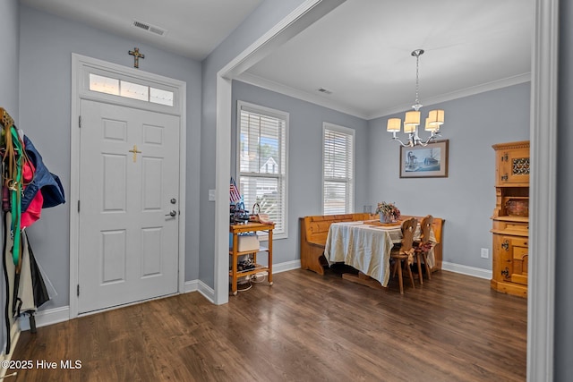 entrance foyer featuring crown molding, a notable chandelier, and dark hardwood / wood-style flooring