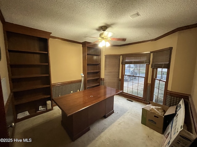 office featuring a textured ceiling, ceiling fan, and crown molding