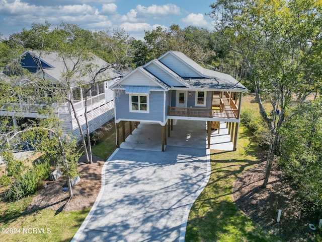 view of front of property featuring a porch and a carport