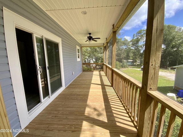 wooden deck featuring ceiling fan