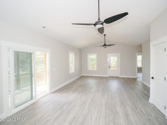 unfurnished living room with vaulted ceiling, ceiling fan, and light wood-type flooring