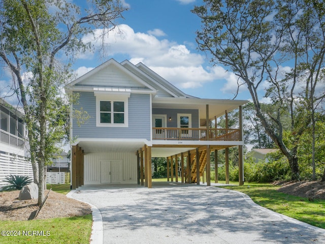 beach home featuring a porch and a carport