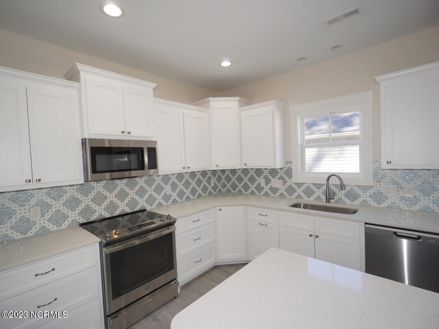 kitchen featuring sink, white cabinets, and stainless steel appliances